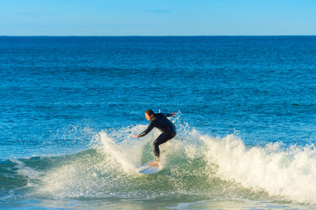 PENICHE, PORTUGAL - DECEMBER 04, 2016: Surfer ride a wave on surfboard in Peniche. Peniche - famous...