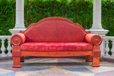 Huge empty red sofa in the gardenの写真素材