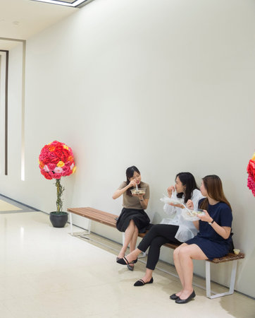 SINGAPORE - FEBRUARY 16, 2017: Women having a lunch on the beanch inside modern shopping mall in Singapore.のeditorial素材