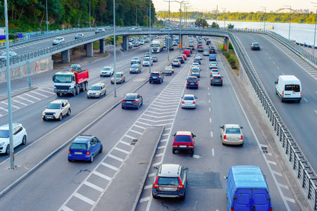 Aerial view of cars at traffic instersection by the Dnipro river embankment, rush hour, Kyiv,...