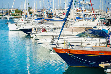 Side view of yachts and motorboats moored in marina of Larnaca, bright sunny day, Cyprus