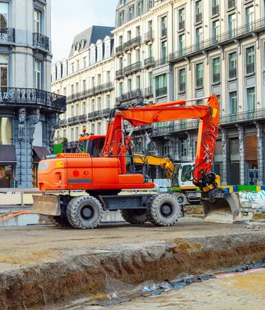 Central street with excavators working at renovation of road in downtown, Brussels, Belgiumの写真素材
