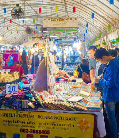 CHIAG MAI, THAILAND - JANUARY 11, 2017: Tourists walking among colorful illuminated stands of asian night souvenir marketのeditorial素材