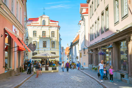 TALLINN, ESTONIA - JULY 14, 2019: Tourists walking by the street at Old Town of Tallinn.のeditorial素材