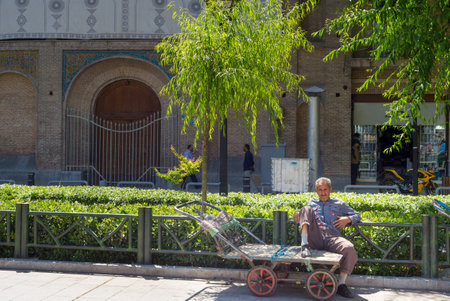 TEHRAN, IRAN - MAY 22, 2017: Man sitting on an empty cart on the street of Tehran. Iran's Unemployment Rate to be 16 % in Dec 2020 as reported by International Monetary Fundのeditorial素材