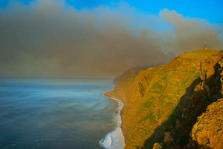 Smoke from burning forest over the ocean. Madeira isand, Portugalの写真素材