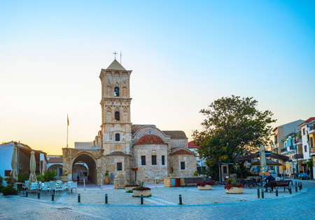 Saint Lazarus church at Larnaka square in evening light, cafes and shops at tiusristic street, Cyprusの写真素材