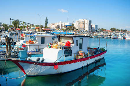 Marina with fishing boats, Larnaca skyline in background, Cyprusの写真素材