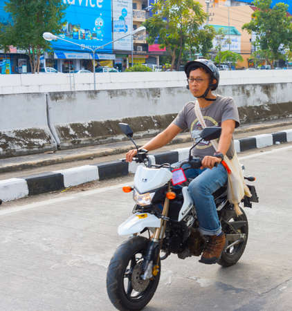 CHIANG MAI, THAILAND - JANUARY 12, 2017: Portrait of unidentified motorbike driver on a  road traffic.のeditorial素材