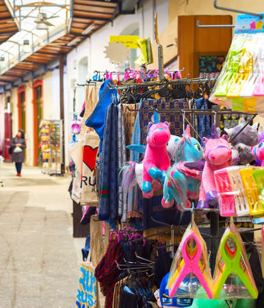 LARNACA, CYPRUS - FEBRUARY 16, 2019: Colorful gifts puppets, kitchen towels on stands at souvenir market in Larnaca touristic downtownのeditorial素材
