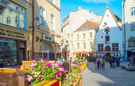 TALLINN, ESTONIA - JULY 14, 2019: People walking by sunny Old Town street view in Tallinn, Estoniaのeditorial素材