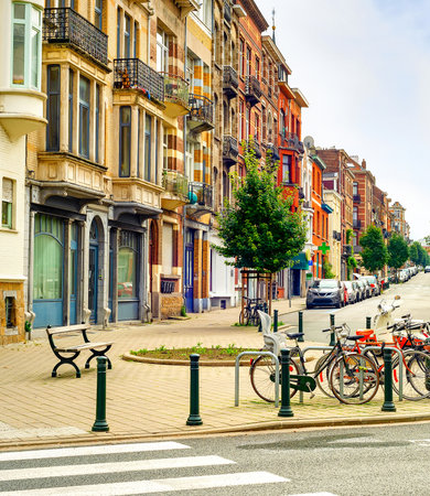 Cityscape, downtown street with typical architecture, residential district, bicycle parking, cars and benches, Brussels, Belgiumの写真素材
