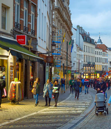 BRUSSELS, BELGIUM - OCTOBER 06, 2019: Crowd of people walking by Old Town shopping street of Brussels at twilightのeditorial素材