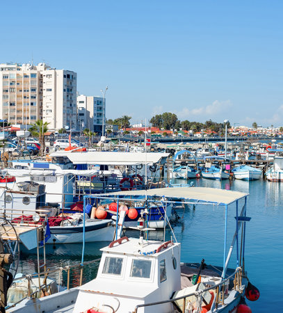 Marina with yachts and cityscape of Larnaca with waterfront apartments in bright sunshine, Cyprusの写真素材