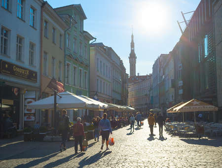 TALLINN, ESTONIA - JULY 14, 2019: People walking by sunny street at Old Town of Tallinn.のeditorial素材