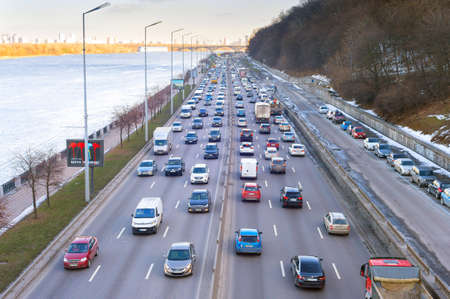KYIV, UKRAINE - MARCH 03, 2021: Traffic on embankment road at sunset. Kyiv is the capital of Ukraineのeditorial素材