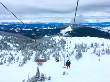 People on a ski lift over the Carpathians mountains. Dragobrat, Ukraineのeditorial素材