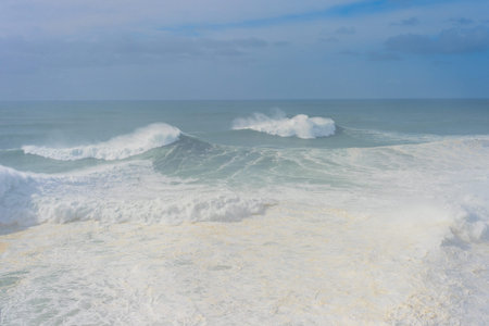 Waves in Atlantic ocean in the mist. Nazare, Portugal