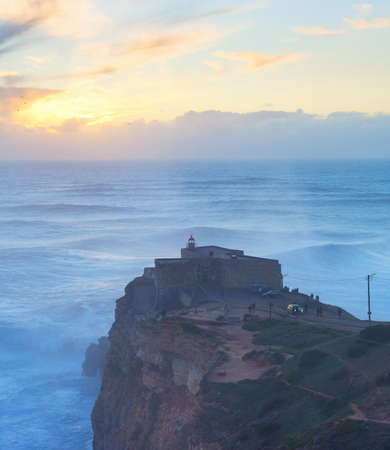 Famous Nazare lighthouse at sunset. Nazare, Portugalの写真素材
