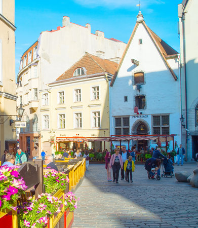 TALLINN, ESTONIA - JULY 14, 2019: People walking by sunny Old Town street view in Tallinn, Estoniaのeditorial素材