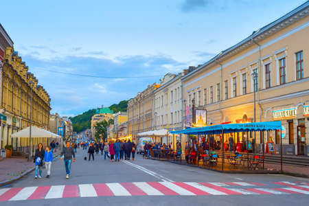 KIEV, UKRAINE - MAY 31, 2020: People walking by Old Town street of Kiev at twilight.のeditorial素材
