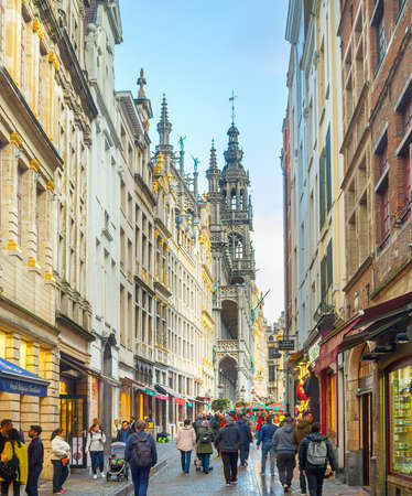 BRUSSELS, BELGIUM - OCTOBER 06, 2019: Crowd of people walking by Old Town shopping street of Brussels, Grand Place in the backgroundのeditorial素材