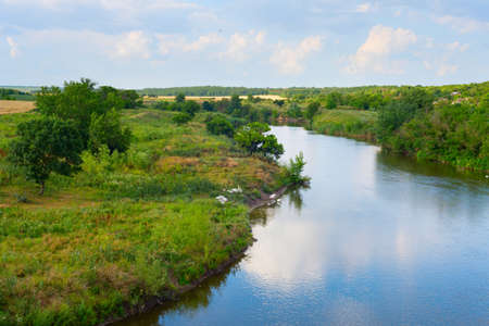 Landscape with a river and flock of white goose. Ukraineの写真素材