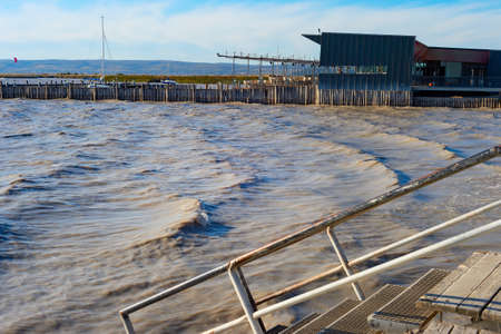 Dramatic landscape with stormy lake, restaurant by the side. Neusiedler See, Austriaの写真素材