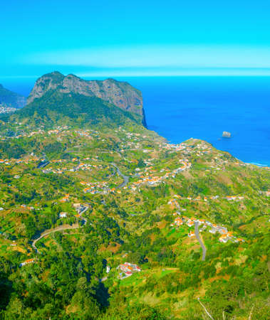 Landscape with Maderia village, mountains and ocean in a bright sunny day. Madeira island, Portugalの写真素材