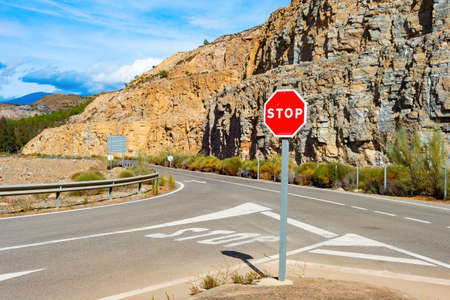 Stop sign on mountain road, sunshine landscape, Spainの写真素材