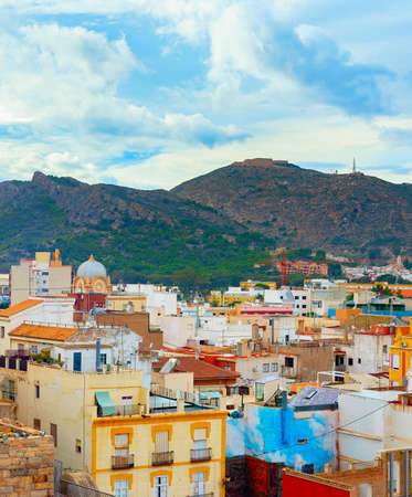Cityscape with mountains and colorful houses in backround, Cartagena, Spainの写真素材