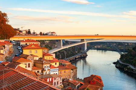 Scenic old town cityscape in sunet light with Ponte Infante Dom Henrique view, Porto, Portugalの写真素材