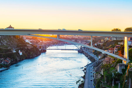Ponte Infante Dom Henrique and Luis bridge view over Douro river at susnet, roead traffic,...