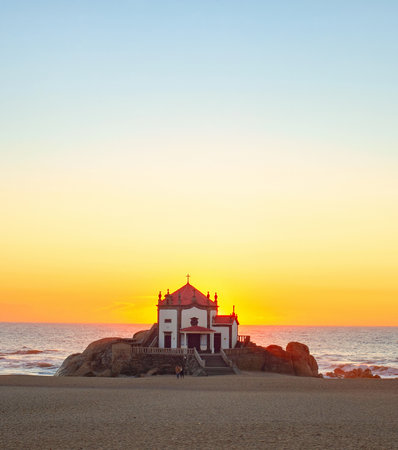 Seascape with Capela do Senhor da Pedra at colorful sunset, POrto, pOrtugalの写真素材