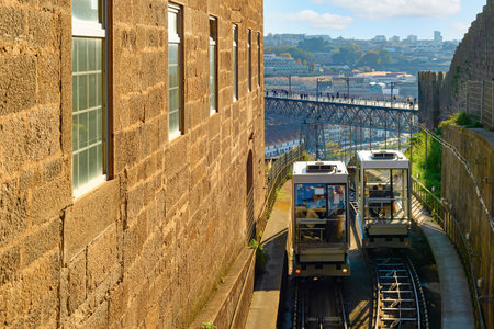 Funicular cabins and Dom Luis bridge view, Gaia in evening sunshine, Porto, Portugalの写真素材