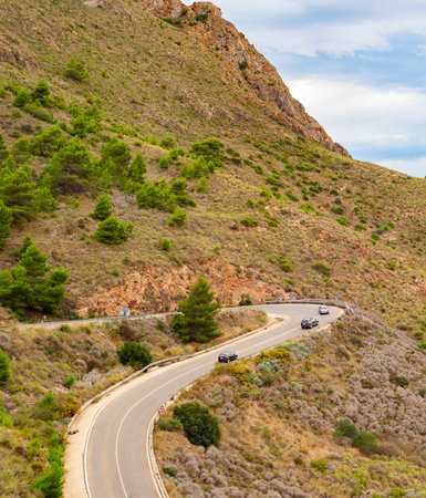 Aerial view of cars on road curve, mountains landscape, Spainの写真素材
