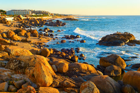 Lavadores beach view with rocks, modern apartments buildings by Atlantic ocean coast, sunset, Porto, Portugalの写真素材