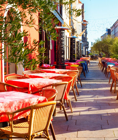 Tables with red cloths on outdoor terrace of restaurant on touristic street, Gyor, Hungaryの写真素材