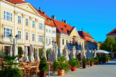 Morning old town view, street terraces of restaurants, green plants and historical architecture, Gyor, Hungaryの写真素材