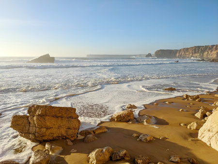 Ocean landscape with sand and rocks on the beach. Sagres, Algarve, Portugalの写真素材