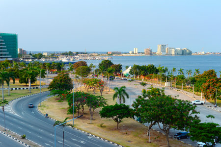 View of a road, yacht club and Ilha de Luanda at sunset. Luanda, Angolaの写真素材