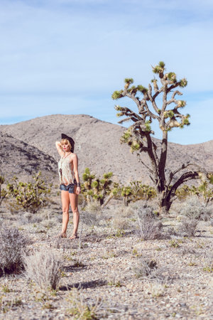 beautiful bohemian girl wearing fashion in desertの写真素材