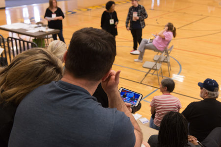 LAS VEGAS, NV - FEBRUARY 20, 2016: People checking poll results at Nevada democratic caucus 2016