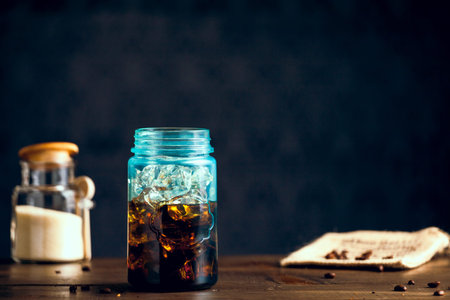 Iced Organic Coffee Served In Blue Mason Jar On Table With Natural Sugar. Copy Space With Selective Focus.の写真素材
