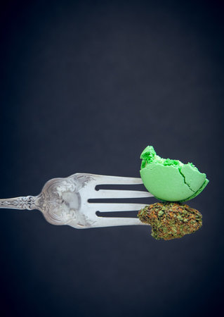 Marijuana Edibles On Vintage Silver For With Cannabis Buds. Vertical Selective Focus With Copy Space...