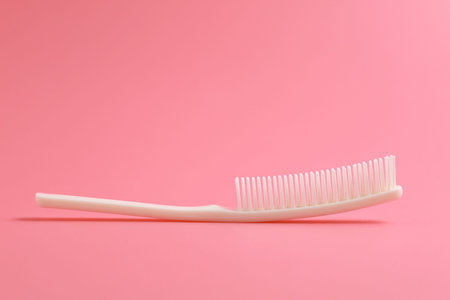 White comb on pink background