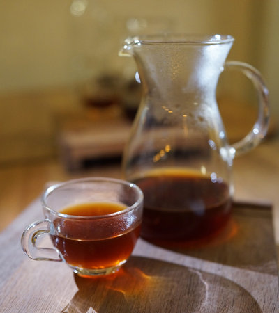 Freshly brewed coffee serving on the table. Brewed coffee is made by pouring hot water onto ground coffee beans, then allowing to brew.の写真素材