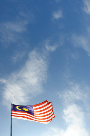 Low Angle View Of Malaysian Flag Against Blue Sky