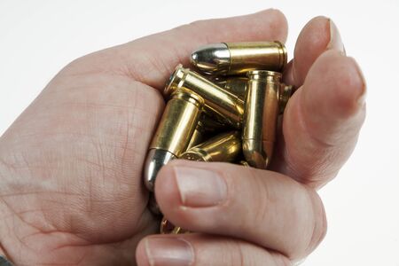 gun and bullets in the shooter's handの写真素材