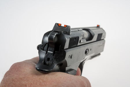 gun and bullets in the shooter's handの写真素材